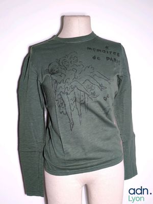 a mannequin wearing a green shirt with a drawing on it