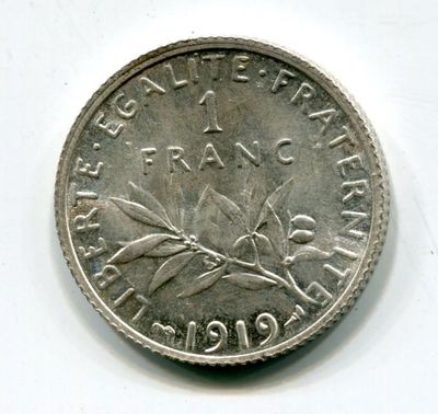 a close up of a coin on a white surface with a white background