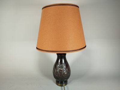 a lamp that has a brown shade on top of it