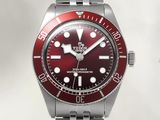 a picture of a watch with a red dial