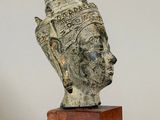 an image of a statue of a woman ' s head on a wooden base
