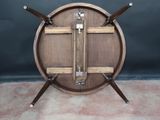 a wooden table with three wooden legs and a wooden top