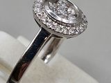 an image of a diamond ring on a white ring stand