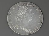 an old silver coin with a woman ' s head on it