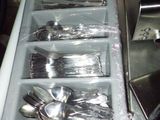 a tray with spoons and spoons in it on a counter