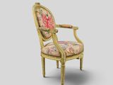 an image of a chair with a floral upholstered back and arms