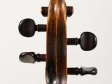 the back of a violin that is sitting on top of a table