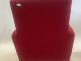 a red chair sitting on top of a white surface