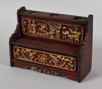 a small wooden box with a design on it
