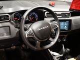 a steering wheel and dashboard of a car in a showroom