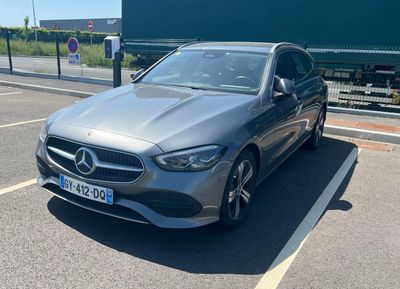 the mercedes cla is parked in the parking lot next to the road
