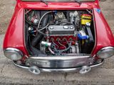 a red car with an engine in the trunk