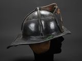 an old fireman ' s helmet on a mannequin head