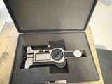 a caliper that is in a case on a table