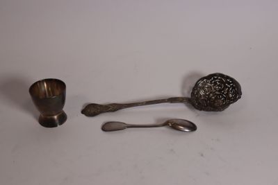 two spoons and a spoon rest on a table