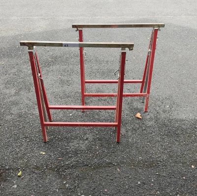 a red table that is sitting in the middle of a parking lot