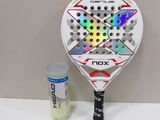 a racquet that is sitting on a table next to a bottle of water