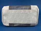 grey and black toiletry bag on a blue background