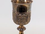 a silver cup that is sitting on a table