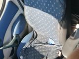 a man that is sitting in the back of a car seat