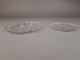 pair of clear glass ashtrays sitting on a white surface