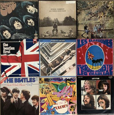 some of the beatles albums are on display on a table