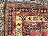 an antique persian rug with a red and blue design on it