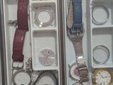 two boxes with watches in them sitting on a desk