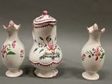 three vases that have been painted with flowers on them