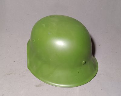 a green helmet sitting on a table with a white background