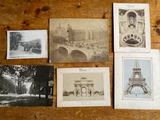 many old postcards on a wooden table with a clock tower