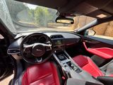 the interior of a car with red leather seats and a steering wheel