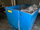a blue trash can with a plastic bag in it