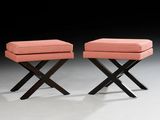 pair of pink upholstered stools with black legs