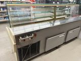 a refrigerated counter in a grocery store