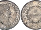 a silver coin with the head of a woman in profile