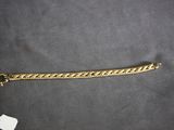 a close up of a gold chain with a tag on it