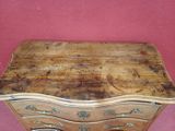 a wooden chest of drawers on a pink background