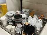 a tray of coffee cups and saucers on a counter