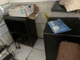 a small room with a fan and a table with boxes on it