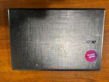 a laptop with a sticker on it sitting on a table