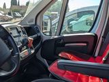 a red seat in the driver ' s seat of a vehicle
