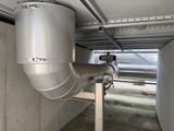 a metal pipe attached to a wall in a building
