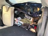 the back of a car with a bunch of items in the trunk