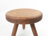 wooden stool with three legs on a white background