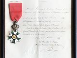 un vieux document orné d'un ruban rouge et d'une médaille