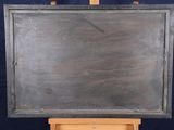 a blackboard on a wooden easel against a blue background