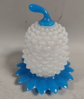 une bougie bleue et blanche posée sur une table