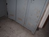 two lockers in the corner of a room that is dirty