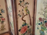 four panels of a room divider with a bird and flowers on them